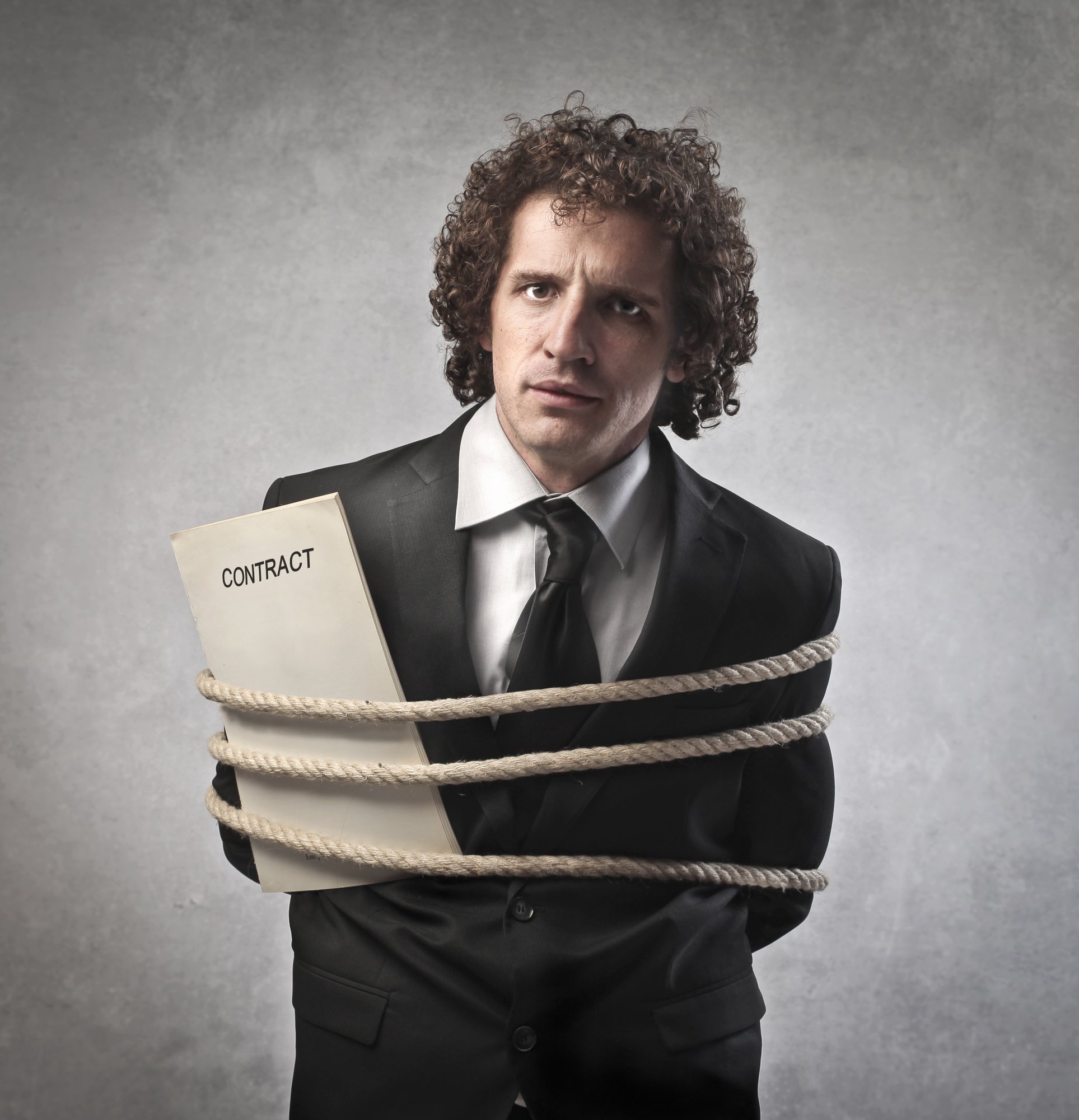 Man bound with rope and a contract regarding information on whether a class action lawsuit is a legally binding contract or not