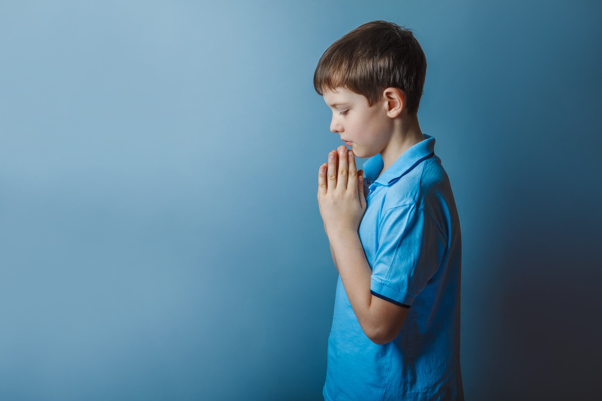 Boy praying during church sexual abuse 