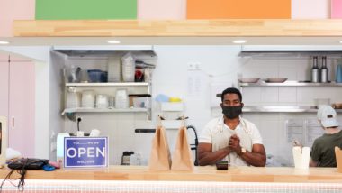 Business owner wearing mask regarding information about business interruption insurance claims