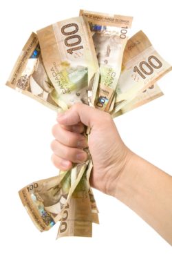 Person holding wad of money regarding the GLGI charitable donation scam class action lawsuit