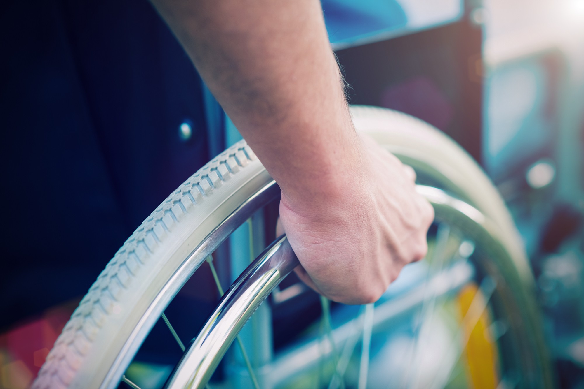 Person holding onto a wheelchair regarding the paralyzed former Humboldt Bronco hockey player filing a lawsuit after deadly bus crash