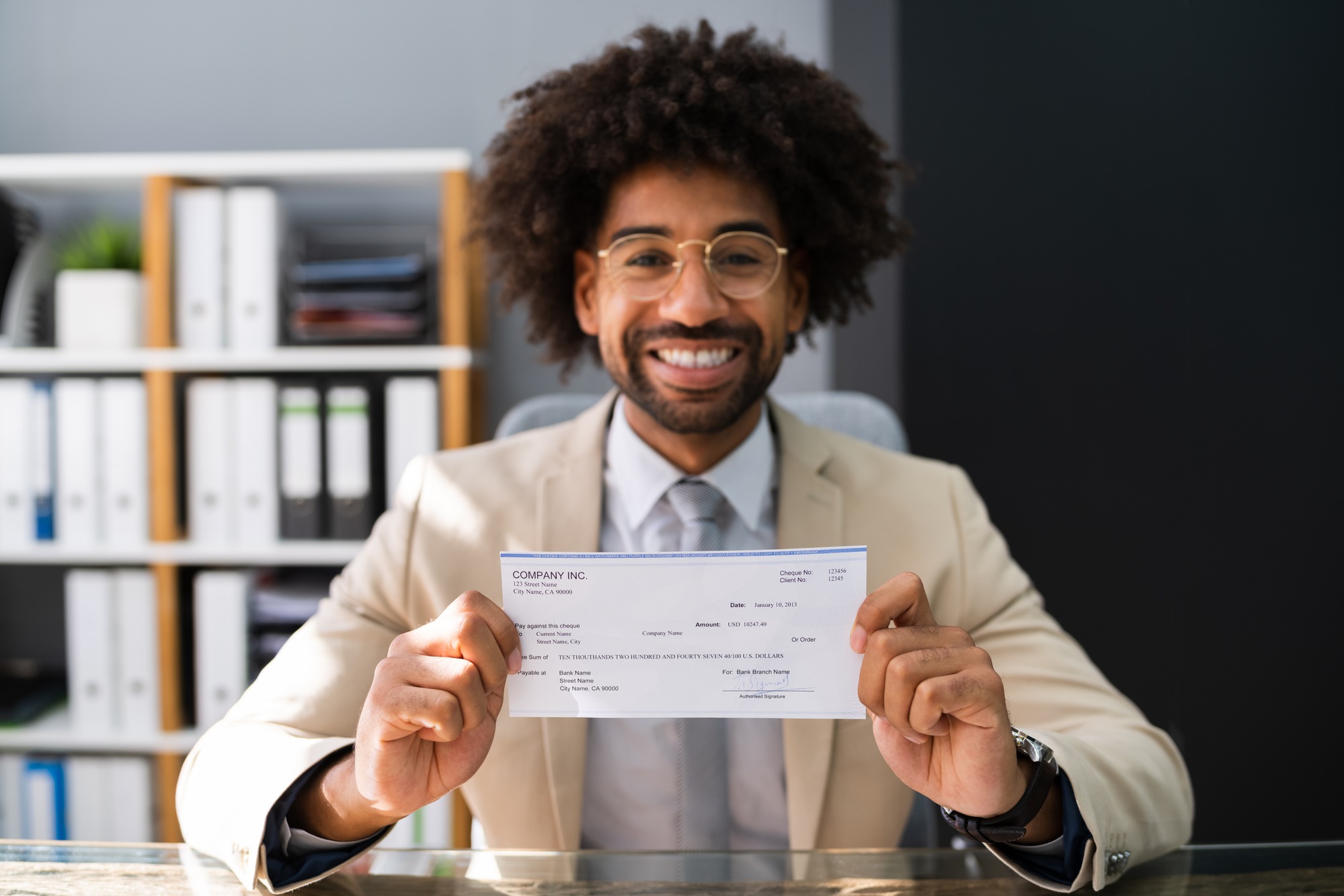 Man holding check regarding the Livingston Employee Overtime Class Action Settlement checks mailed