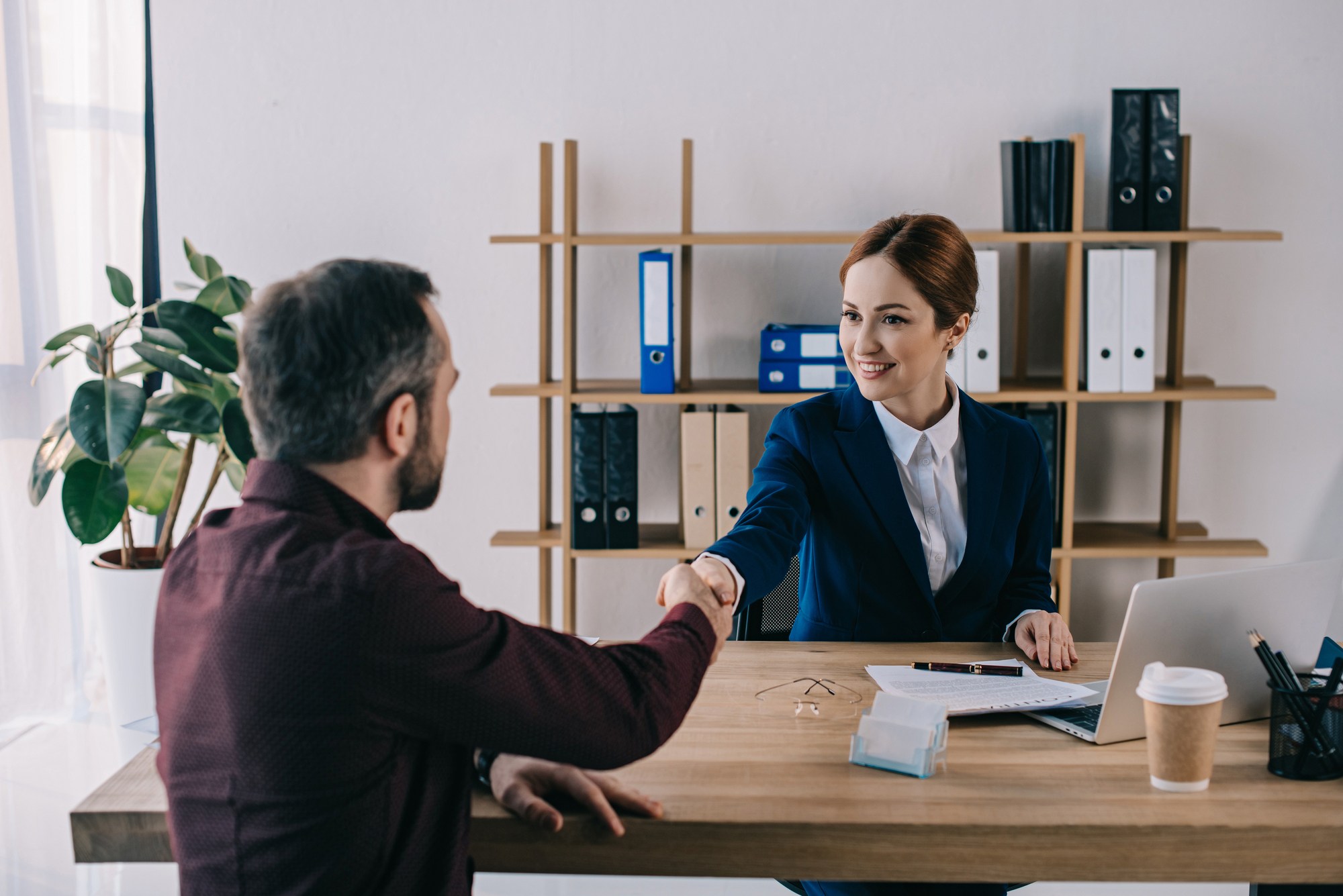 Long-term disability lawyer shaking clients hand
