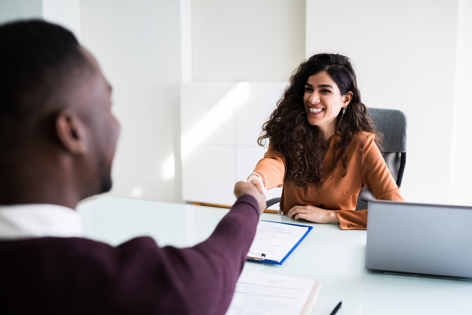Lawyer shaking hands regarding information on when to hire a long-term disability Ontario lawyer