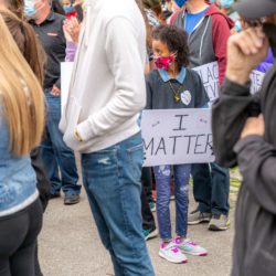 Little girl holding sign regarding the Scholar Strike Canada