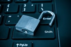 Open silver padlock on black computer keyboard - yahoo