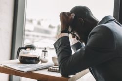 business man distressed after COVID-19 insurance claims denied due to force majeure