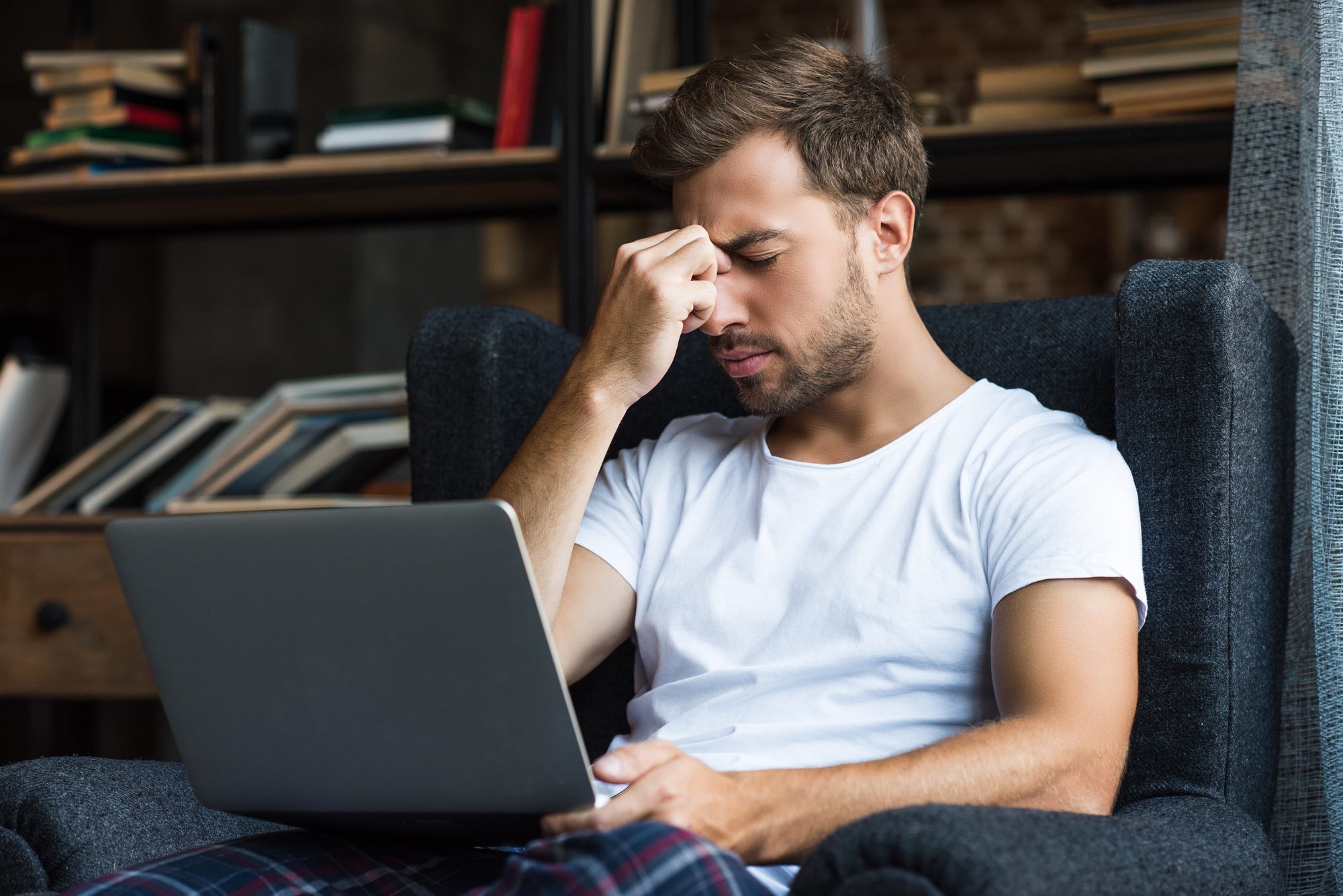 man on laptop accused on assault on Facebook