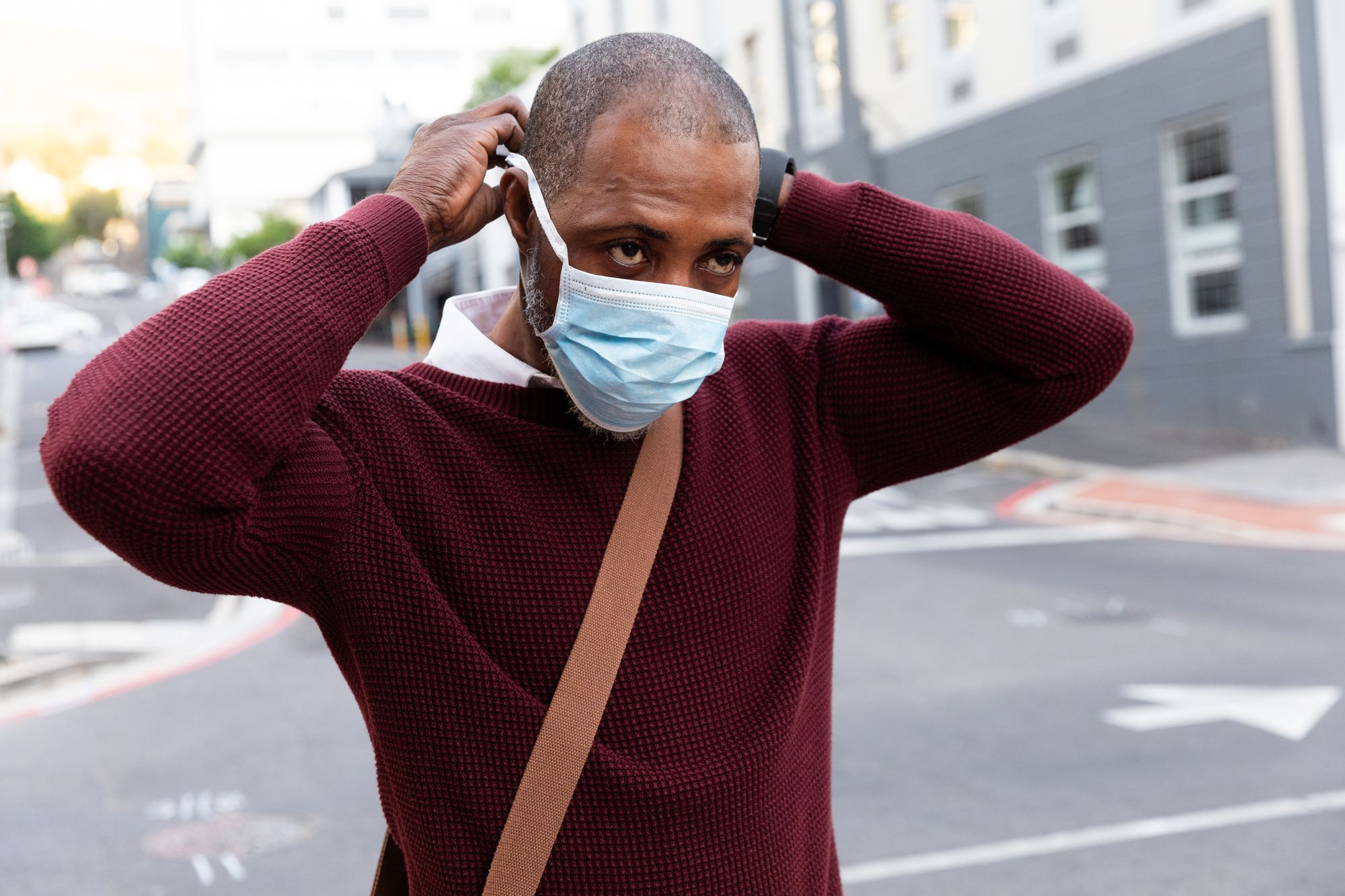 Man putting on mask regarding the mandatory mask lawsuit