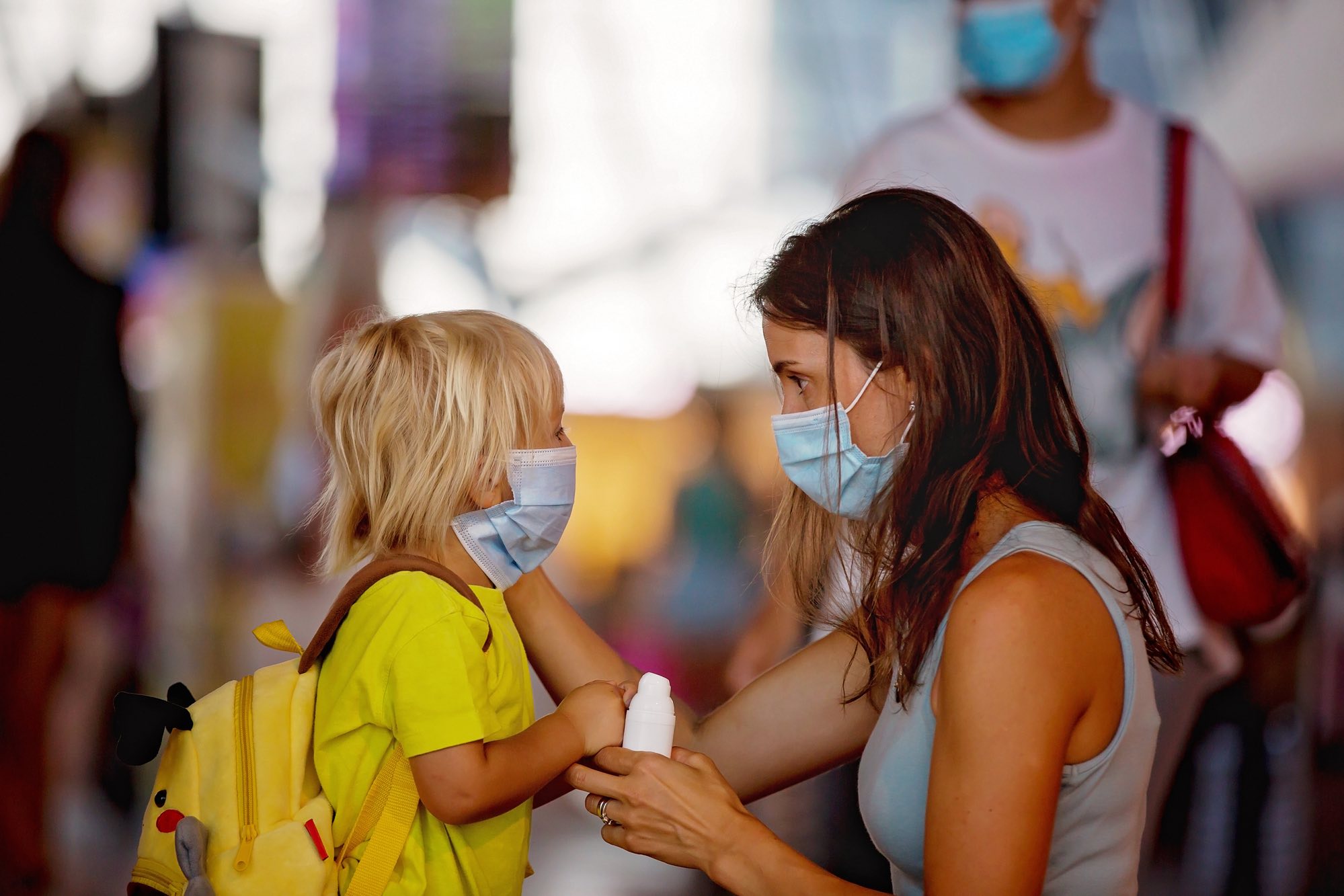 mother and child in face mask indoors as fines given to those who don't wear masks