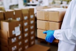 Person carrying boxes regarding the n95 mask shipment 