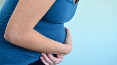 Pregnant woman holding belly regarding the compensation settlement approved for those negatively impacted by morning sickness drug thalidomide