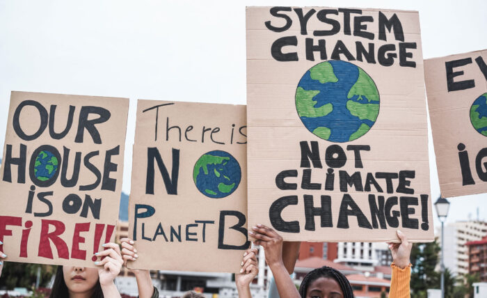 Young group of demonstrators on road from different culture and race protest for climate change.