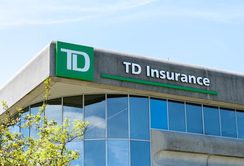 Close up of TD Insurance signage against a blue sky.