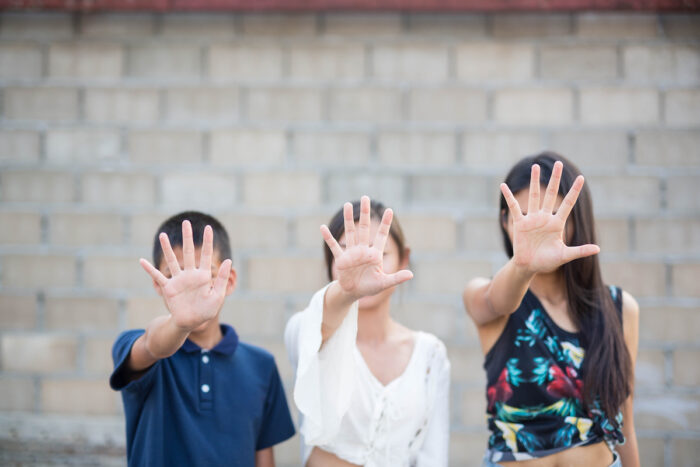 Photo of children standing up to abuse.