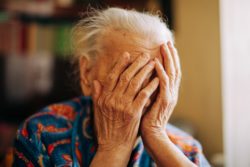 Upset senior woman regarding the Camilla Care Community class action lawsuit 