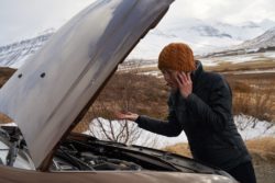 Woman having car trouble regarding the Fiat Chrysler Automobile class action lawsuit filed