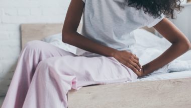 Woman holding hip in pain regarding the Wright Profemur Hip Implant Class Action Settlement rescheduled
