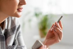woman holding joint regarding the tainted Organigram class action lawsuit claiming the pesticides in the cannabis makes users sick when burned and inhaled