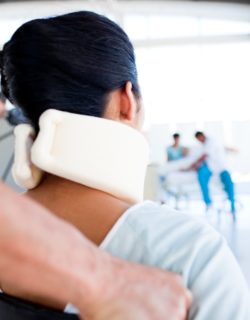 Woman in neck brace regarding the Alberta tour bus crash class action lawsuit filed