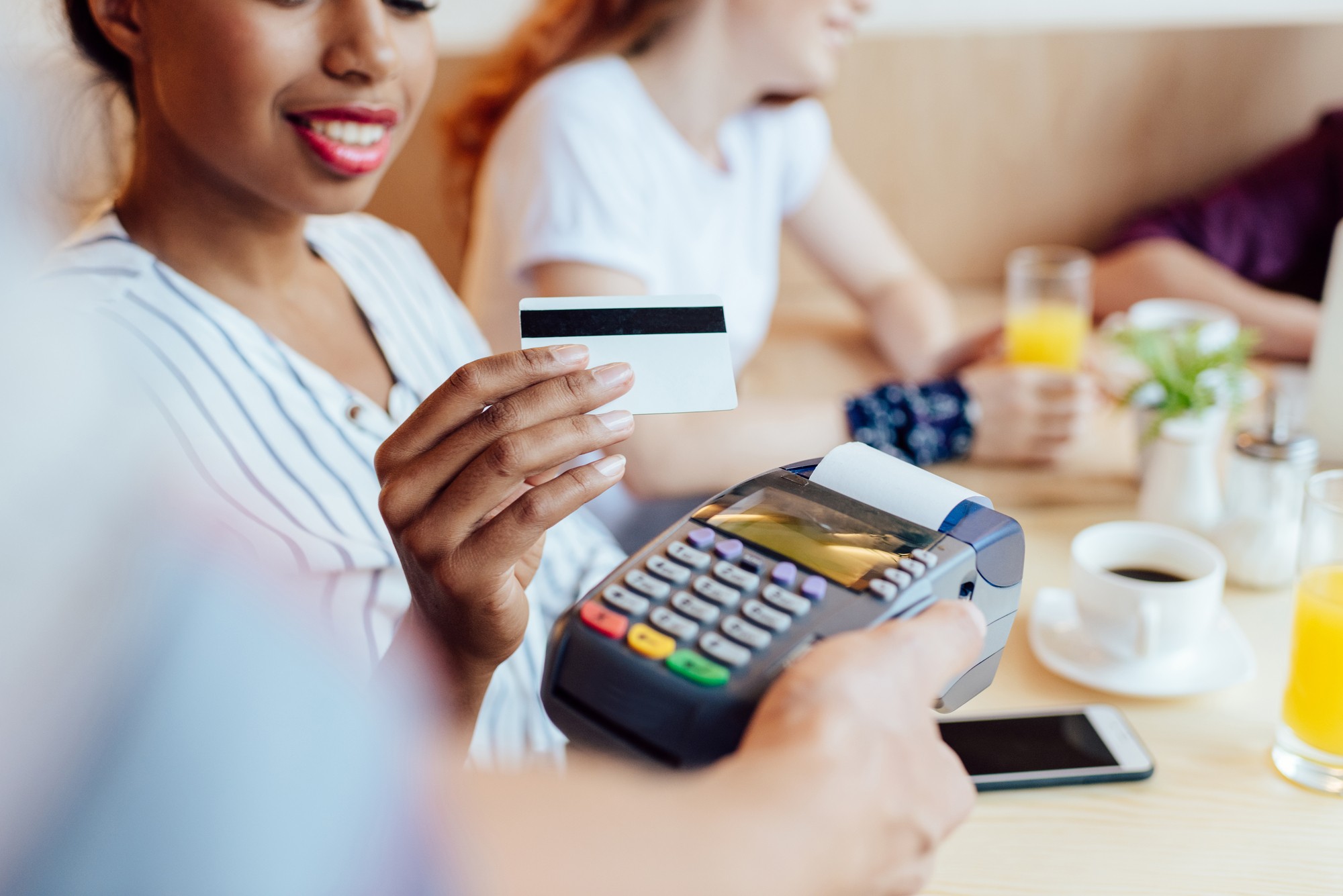Woman using credit card regarding the Capitol One data breach class action lawsuit filed